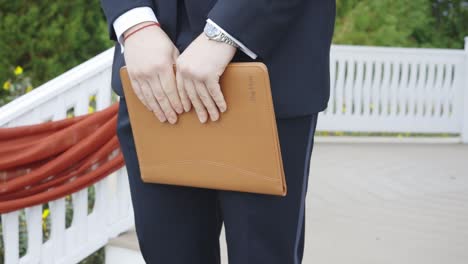 Officiant-holds-folder-at-ceremony