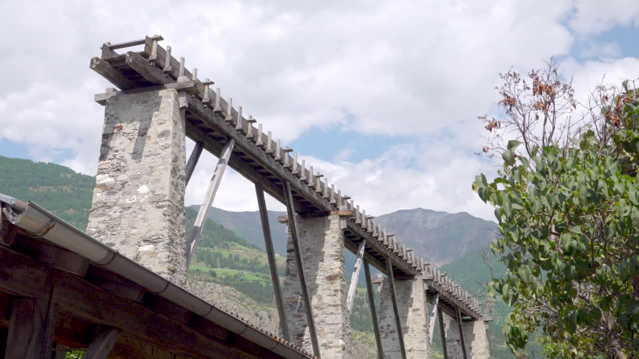 Ancient Wooden Bridge in Mountainous Landscape