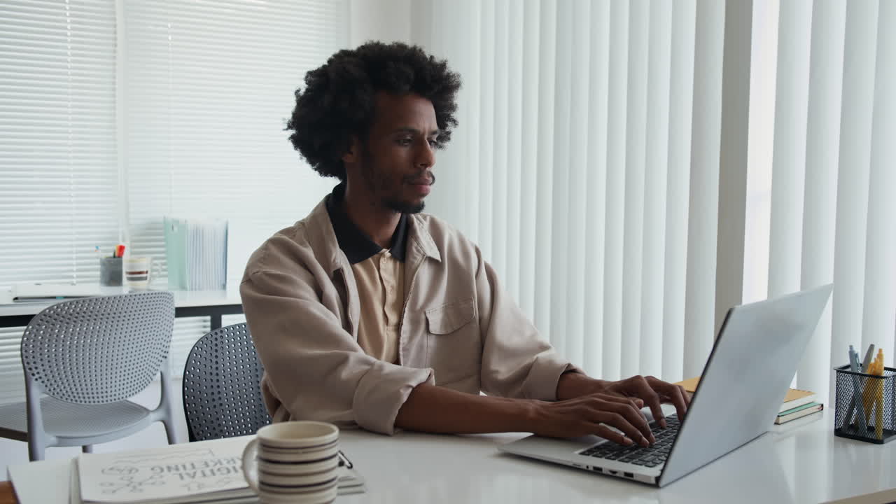 Portrait of Male Marketer in front of Laptop at Workplace