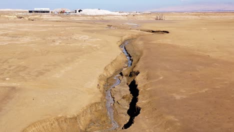 massive sinkhole with water and erosion in the dead sea region