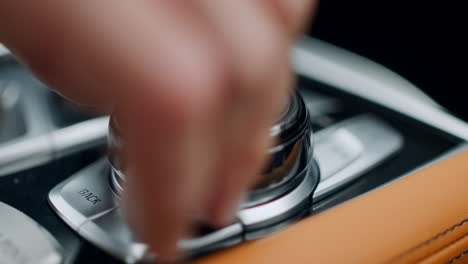 man using control knob at car