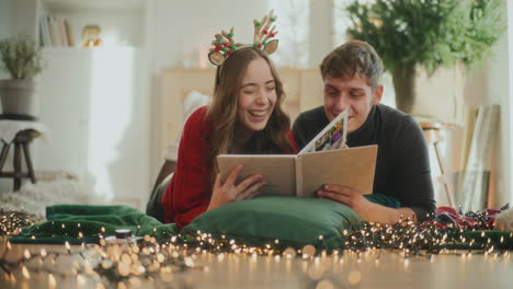 Girlfriend-and-boyfriend-with-photo-album-at-home