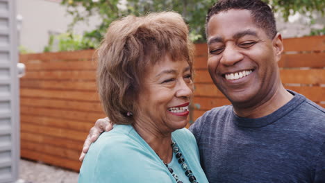 Happy-senior-black-woman-and-her-middle-aged-son-embracing,-head-and-shoulders,-close-up