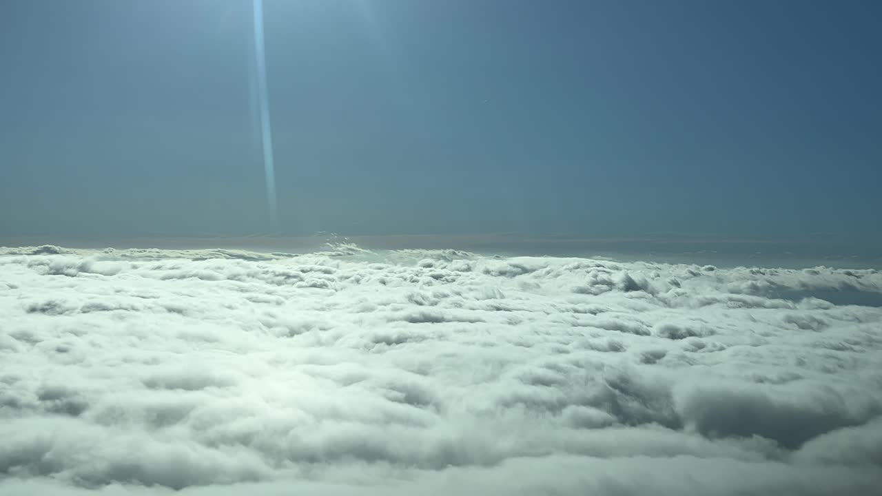 Aerial view of a sea of clouds as seen by the pilot&rsquo;s in a real flght over the clouds in a bright morning