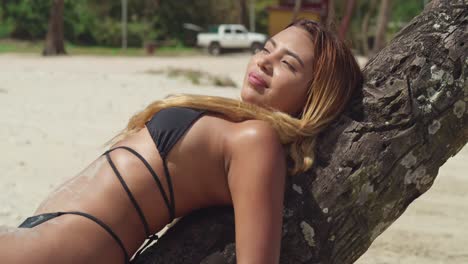 a girl in her bikini relishes the beauty of a caribbean tropical beach with pristine white sand