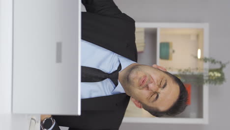 vertical video of home office worker man has stomachache.