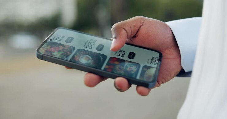 Person Scrolling Through Food Delivery App on Smartphone