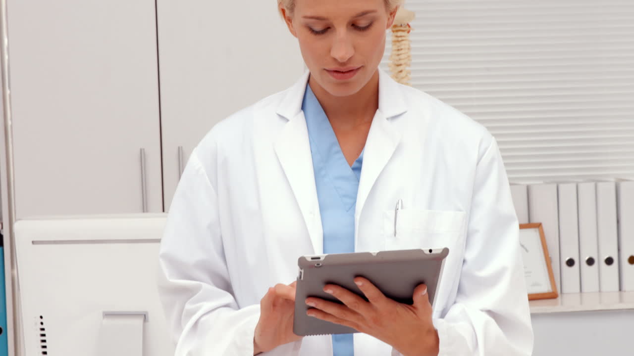 Pretty doctor using tablet pc