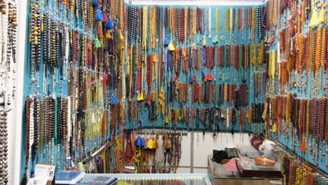 tracking shot of colourful beads at shop