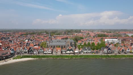 revealing drone shot of a church in volendam, the netherlands