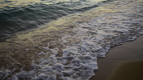 waves on the beach at sunset/sunrise