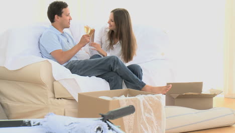 pareja brindando con un vaso de vino blanco durante la mudanza