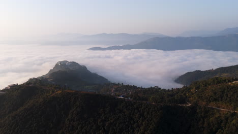 drone circling the gyarjati town in the hills of pokhara, foggy sunrise in nepal