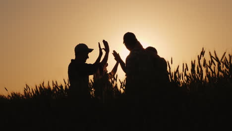 the team of farmers raise their hands up together in a sign of success and confidence in the team