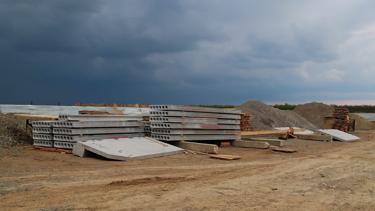 Construction Site with Concrete Materials under Cloudy Sky