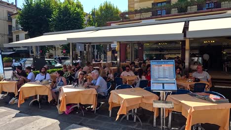 people dining and walking in piazza tasso