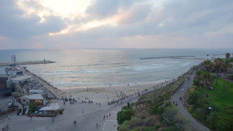 Hilton-Beach-with-surfers-on-a-cloudy-summer-day---Push-in-shot