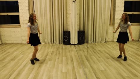 slow motion talented teenage female dancer dancing in front of a mirror
