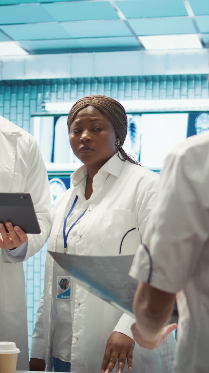 Vertical Video Physician and nurses reviewing medical charts and test results