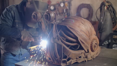 welding a rusty metal sculpture