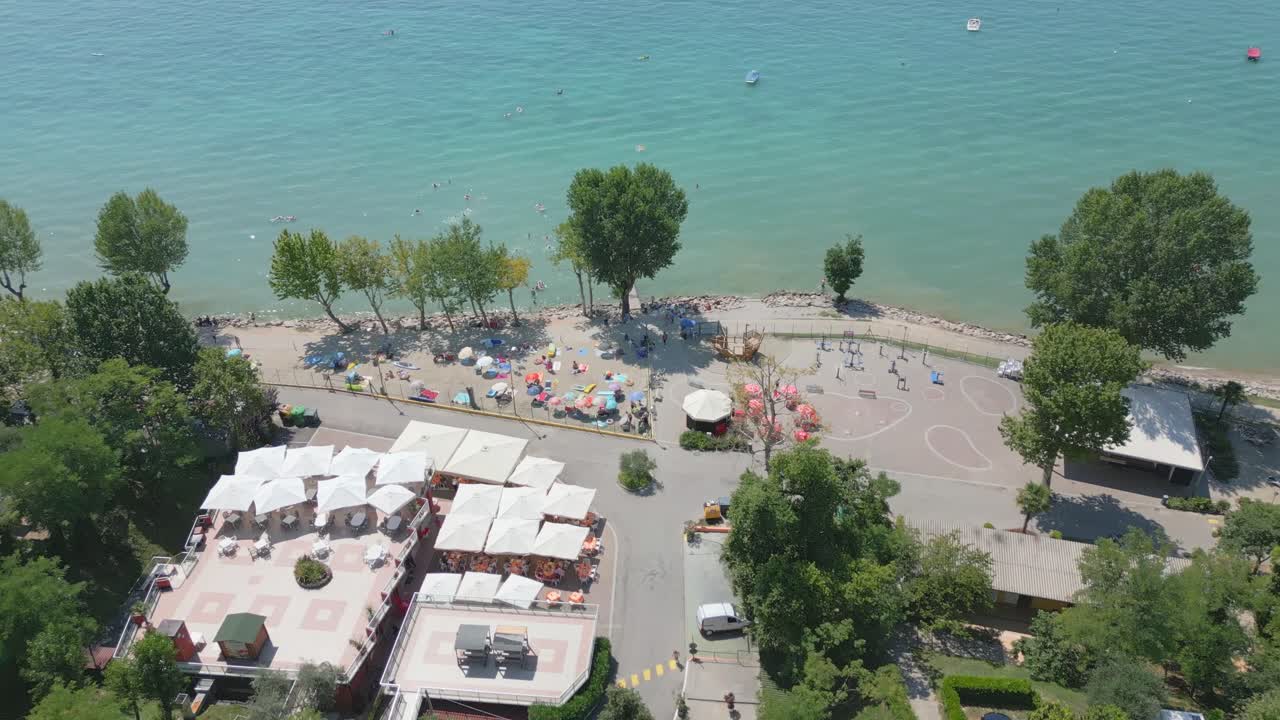 Bird's eye view above lake garda italy lakeside beach shoreline facilities