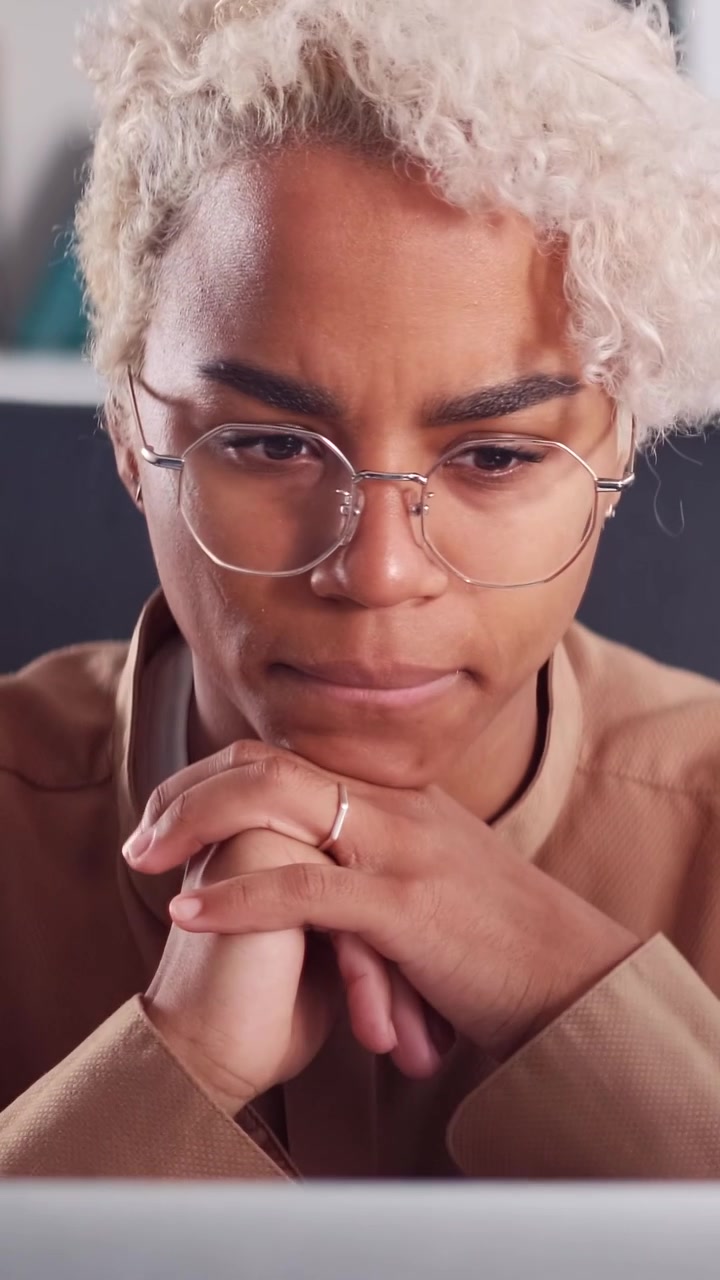 Close up of pensive african american woman in glasses thinking deeply in front