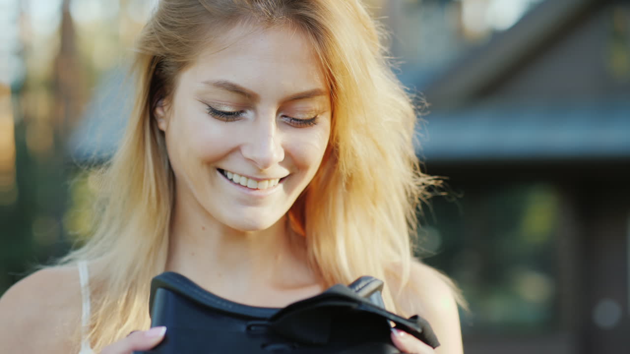 A Beautiful Woman Invites Into The World Of Virtual Reality Smiling Putting On 3d Helmet On Camera 4