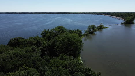 aerial parallax of blue midwestern lake in iowa