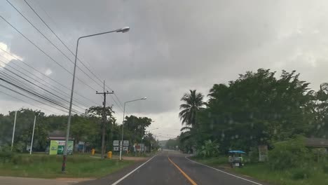 driving along a countryside road in thailand with drivers vie of the road