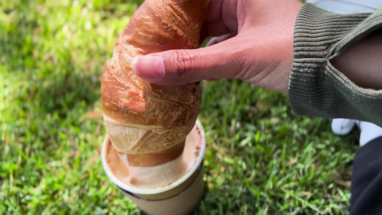 Dipping Croissant in Coffee Latte Picnic