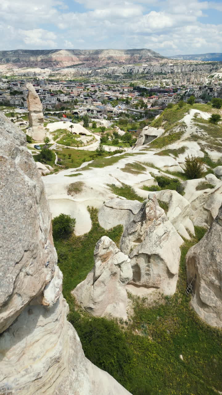 Vertical drone shot over the Ferry chimneys, sunny day in Cappadocia, Turkey