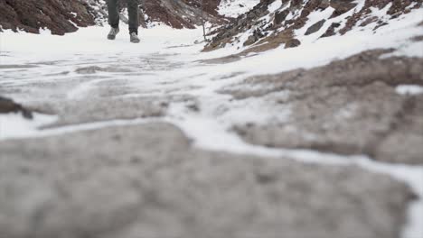 person hiking in snowy volcanic landscape