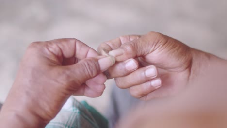 Man-cleaning-his-fingernails-with-blade-top-view