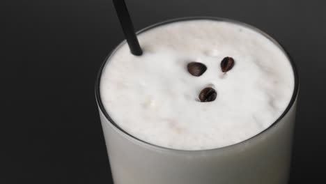 coffee beans placed on iced cappuccino froth