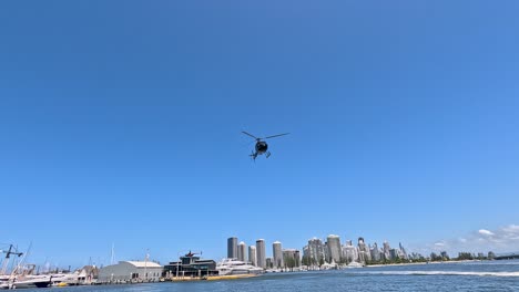 helicopter flying over marina and city skyline