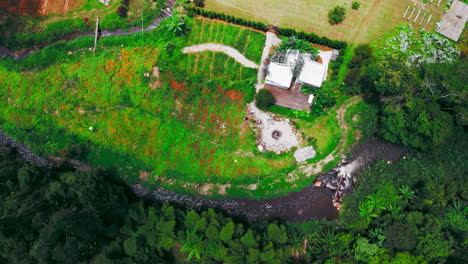 Serene camp house nestled by a tranquil forest stream, surrounded by lush greenery. Perfect for nature, camping, or relaxation projects