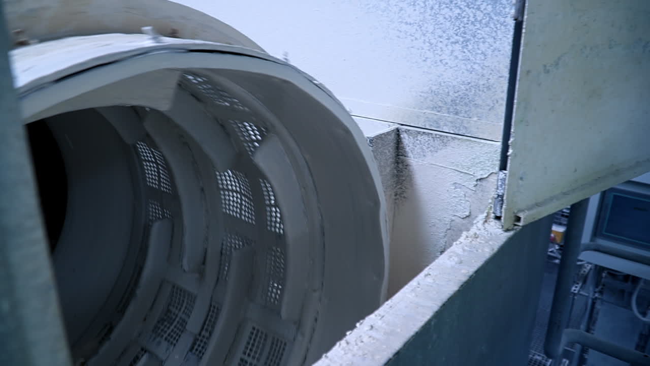 White kaolin clay mixed up with water being filtered at the factory. Up-to-date kaolin industry manufacturing.