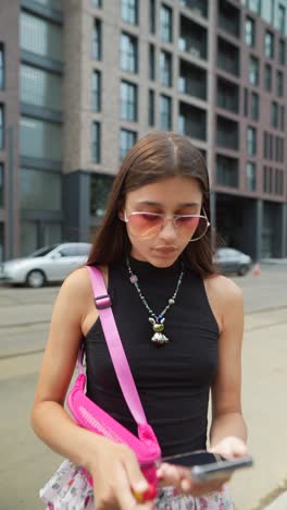 young woman using smartphone in city