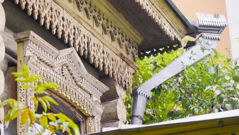 ornate wooden house facade with carvings and guttering