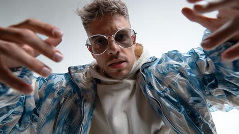 stylish man reaching out in slow motion on white background
