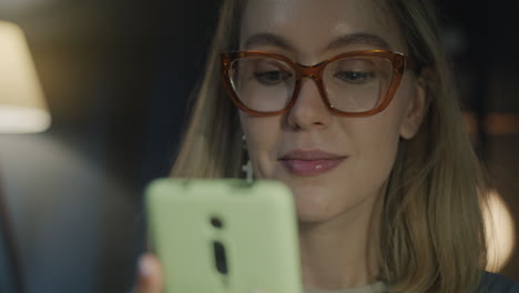 Woman looking at her smartphone at night