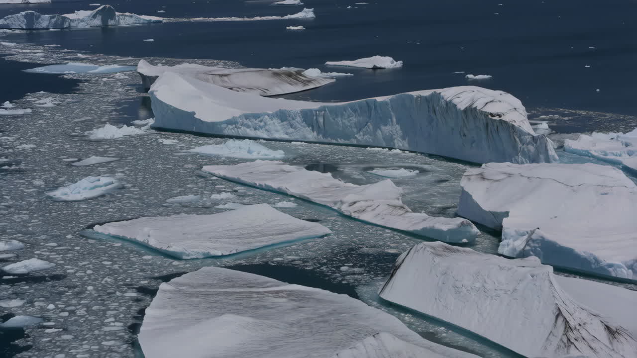 Aerial view of majestic icebergs and expansive sea ice in a polar ocean