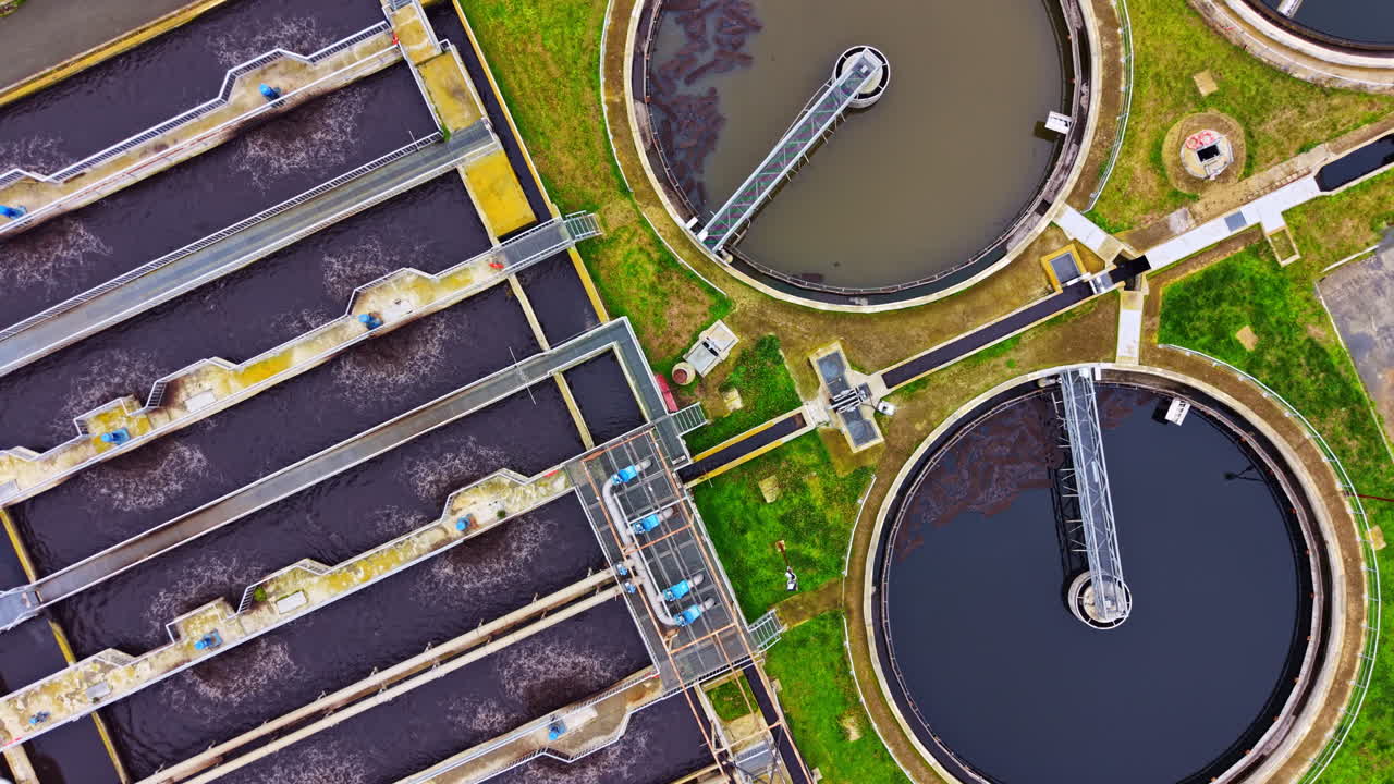 Water treatment facility in operation with tanks and equipment visible from above during daylight hours