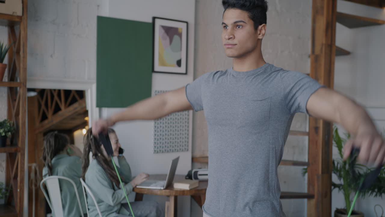 Man working out with resistance bands at home