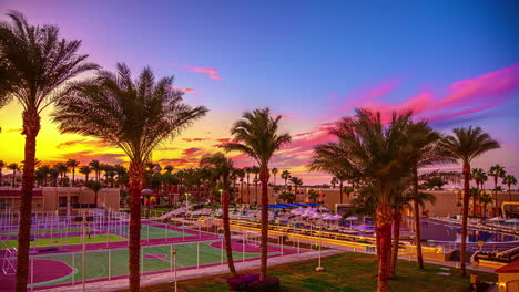 colorful, dreamy sunset over a resort sport complex - time lapse