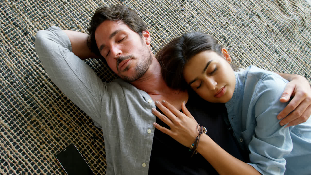 Couple relaxing together on floor 4k