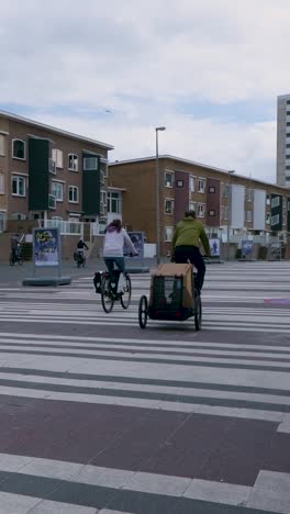 cityscape with people cycling on a pedestrian street