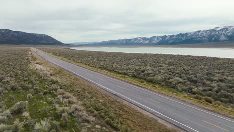 aerial - truck on highway next to scipio lake, utah, wide panoramic reverse shot