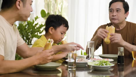 asian men and boy sitting at the table