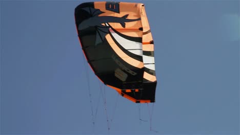 people engage in the fast moving sport kite boarding  along a sunny coast 5